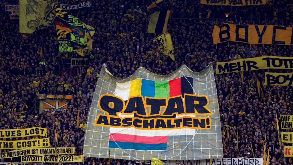 BOYCOTT QATAR 2022 inscribed in yellow and black Banner in Dortmund
